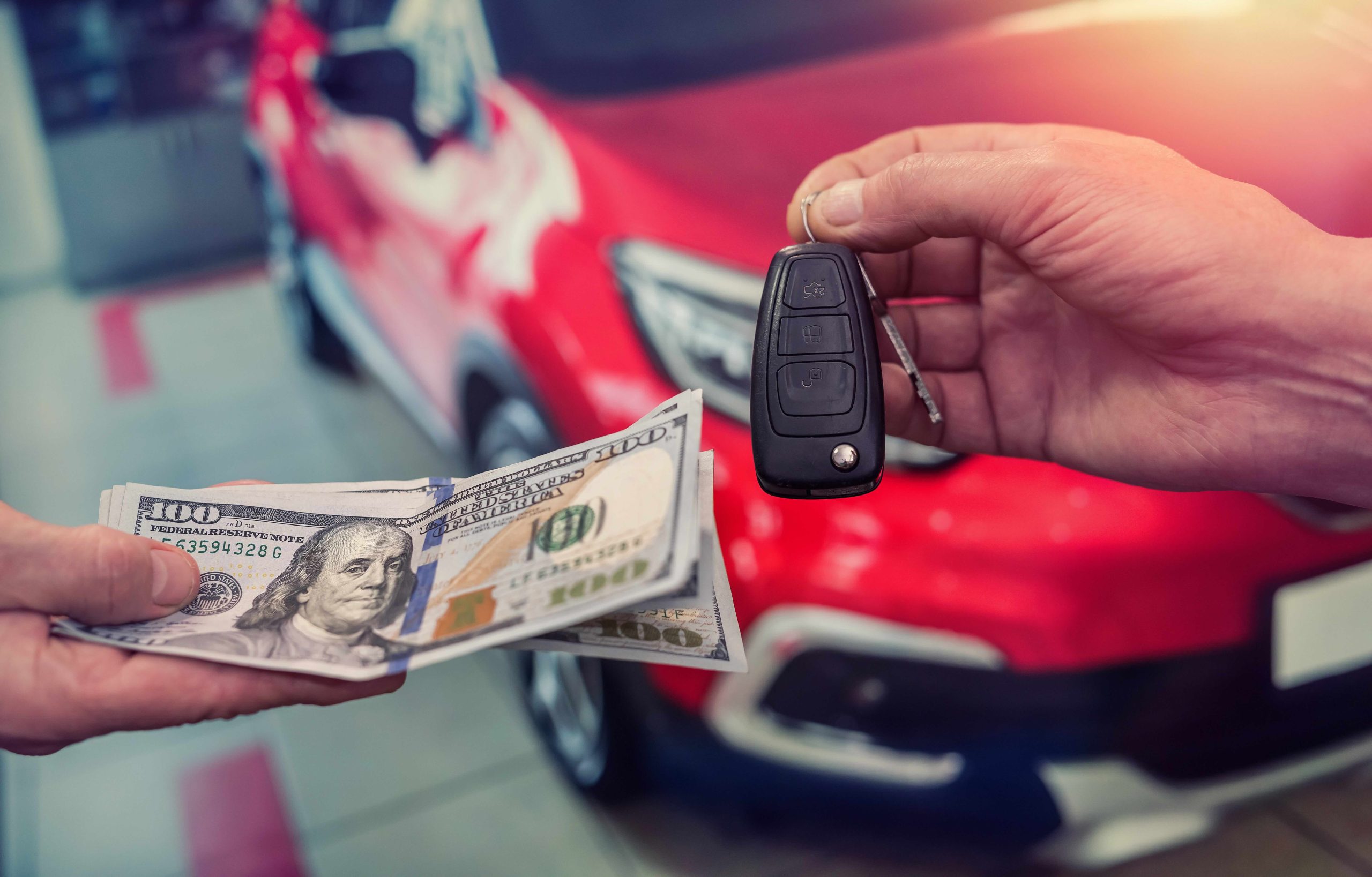 Dealer and customer exchanging cash and keys.